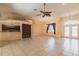 Large open-concept living space, connecting to the kitchen and foyer, featuring tile floors and lots of natural light at 25538 Rampart Blvd, Punta Gorda, FL 33983