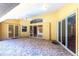Covered patio featuring decorative stone flooring and sliding glass doors to the interior at 25538 Rampart Blvd, Punta Gorda, FL 33983