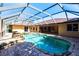 Beautiful backyard pool area with a waterfall feature and a screened-in enclosure at 25538 Rampart Blvd, Punta Gorda, FL 33983