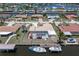 Aerial view of a waterfront home featuring a screened-in pool and boat dock at 259 Fields Ter, Port Charlotte, FL 33952