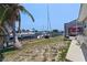 Backyard featuring a boat dock, waterfront, and a screened-in patio at 259 Fields Ter, Port Charlotte, FL 33952