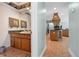 Bathroom with granite counters and decorative mirror provides warmth and charm at 259 Fields Ter, Port Charlotte, FL 33952