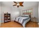 Cozy bedroom features hardwood floors, a ceiling fan, and a queen bed at 259 Fields Ter, Port Charlotte, FL 33952