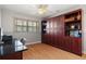 Bedroom features wood floors, built-in wood shelving, and a ceiling fan at 259 Fields Ter, Port Charlotte, FL 33952