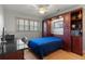 Murphy bed is pulled down in the bedroom featuring wood floors and built-in shelving at 259 Fields Ter, Port Charlotte, FL 33952