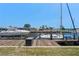 Waterfront view of a private dock with boats under a clear blue sky at 259 Fields Ter, Port Charlotte, FL 33952