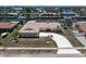 Aerial view of a single-story home with a circular driveway and waterfront access at 259 Fields Ter, Port Charlotte, FL 33952