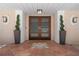 Close-up of the front entrance with a decorative tile landing and glass-paneled double doors at 259 Fields Ter, Port Charlotte, FL 33952