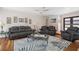 Open-concept living room with comfortable seating, ceiling fan, and a decorative rug at 259 Fields Ter, Port Charlotte, FL 33952