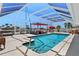 Inviting backyard pool featuring clear blue water, patio seating, and a screened enclosure at 259 Fields Ter, Port Charlotte, FL 33952