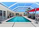 Backyard oasis featuring an inviting pool with a screened enclosure and stylish outdoor seating areas at 259 Fields Ter, Port Charlotte, FL 33952