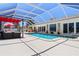 Stunning backyard pool features a patio, hot tub, and screened enclosure for ultimate relaxation and privacy at 259 Fields Ter, Port Charlotte, FL 33952