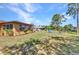 This home offers a serene backyard with beautiful landscaping and a relaxing seating area to enjoy the view at 2626 Auburn Blvd, Port Charlotte, FL 33948