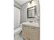 Bathroom featuring a modern sink and vanity, mosaic-framed mirror, and tub/shower combination with white shower curtain at 2626 Auburn Blvd, Port Charlotte, FL 33948