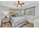 Cozy bedroom featuring wood-look flooring, two large windows, and neutral tones at 2626 Auburn Blvd, Port Charlotte, FL 33948