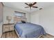 Comfortable bedroom featuring a large bed, ceiling fan, and natural lighting at 2626 Auburn Blvd, Port Charlotte, FL 33948