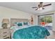 Relaxing bedroom with ceiling fan and sliding doors leading to an outdoor patio for easy access at 2626 Auburn Blvd, Port Charlotte, FL 33948