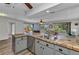 Open kitchen featuring stainless steel appliances, tile countertops, and views of the home's living area at 2626 Auburn Blvd, Port Charlotte, FL 33948