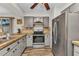 Well-lit kitchen featuring updated appliances, tile backsplash, and neutral cabinetry for a modern feel at 2626 Auburn Blvd, Port Charlotte, FL 33948