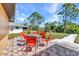 Charming back patio with a dining area offers a peaceful setting with beautiful backyard views at 2626 Auburn Blvd, Port Charlotte, FL 33948