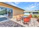 Back patio with seating, ideal for outdoor entertaining and enjoying the lush backyard at 2626 Auburn Blvd, Port Charlotte, FL 33948
