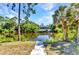 Beautiful waterfront view of a calm waterway surrounded by lush trees, enhancing the homes peaceful setting at 2626 Auburn Blvd, Port Charlotte, FL 33948