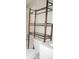 Bathroom featuring updated fixtures and a convenient over-the-toilet storage unit for organization at 26430 Rampart Blvd # 511, Punta Gorda, FL 33983
