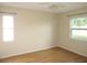 Bedroom with wood floors and natural light from two windows at 26430 Rampart Blvd # 511, Punta Gorda, FL 33983