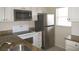 Close-up of the kitchen featuring granite countertops and stainless steel appliances at 26430 Rampart Blvd # 511, Punta Gorda, FL 33983