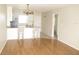 Open living space featuring the kitchen bar with stools, laminate floors, and neutral paint at 26430 Rampart Blvd # 511, Punta Gorda, FL 33983