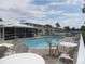 Inviting community pool with lounge seating offers relaxation and a refreshing escape at 26430 Rampart Blvd # 511, Punta Gorda, FL 33983