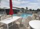Relaxing community pool with ample seating and shade, creating a resort-like atmosphere at 26430 Rampart Blvd # 511, Punta Gorda, FL 33983