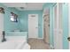 Bright bathroom with tile flooring, glass-enclosed shower, bathtub, and neutral wall paint at 3225 Magnolia Way, Punta Gorda, FL 33950