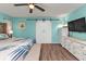 Comfortable bedroom with an accent wall, sliding closet doors, and a bed with blue and white bedding at 3225 Magnolia Way, Punta Gorda, FL 33950