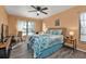 Comfortable bedroom with a ceiling fan, carpeted floors, and large windows at 3225 Magnolia Way, Punta Gorda, FL 33950