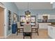 Dining area with a chandelier, wine rack, and access to the kitchen and outdoor seating at 3225 Magnolia Way, Punta Gorda, FL 33950