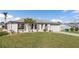 Charming single-story home with a well-manicured lawn and tropical landscaping at 3225 Magnolia Way, Punta Gorda, FL 33950