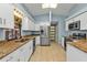Bright kitchen with stainless steel appliances, granite countertops, a skylight, and a sliding barn door at 3225 Magnolia Way, Punta Gorda, FL 33950