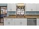 The kitchen features granite countertops, stainless steel appliances, and a window overlooking the water at 3225 Magnolia Way, Punta Gorda, FL 33950