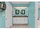 Bright, light-blue ensuite bathroom featuring a double vanity with granite counters and white cabinets at 3225 Magnolia Way, Punta Gorda, FL 33950