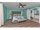 Light-blue main bedroom with a decorative ceiling fan and ensuite bathroom with a barn door at 3225 Magnolia Way, Punta Gorda, FL 33950