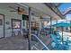 Outdoor patio area with a kitchen, ceiling fans, furniture and canal views at 3225 Magnolia Way, Punta Gorda, FL 33950