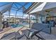 Screened-in pool with canal views, patio furniture, and a grill at 3225 Magnolia Way, Punta Gorda, FL 33950
