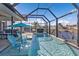 In-ground pool and canal views with patio furniture and full screen enclosure at 3225 Magnolia Way, Punta Gorda, FL 33950