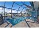 Screened in pool with patio seating overlooking a canal and private dock on a sunny day at 3225 Magnolia Way, Punta Gorda, FL 33950