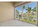 Balcony view with a screen, overlooking a canal, palm trees, and clear blue sky at 3314 Wood Thrush Dr # 124, Punta Gorda, FL 33950