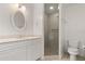 Bathroom featuring a glass enclosed shower, white cabinets, and a toilet at 3314 Wood Thrush Dr # 124, Punta Gorda, FL 33950