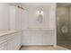 Well-lit bathroom with dual vanities, a framed mirror, a glass-enclosed shower with a palm tree design at 3314 Wood Thrush Dr # 124, Punta Gorda, FL 33950