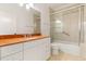 Bathroom with a shower over the tub, a marble vanity and sink, and tile flooring at 3314 Wood Thrush Dr # 124, Punta Gorda, FL 33950
