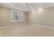 Bright bedroom with large window offering outdoor views, complemented by ceiling fan and recessed lighting at 3314 Wood Thrush Dr # 124, Punta Gorda, FL 33950